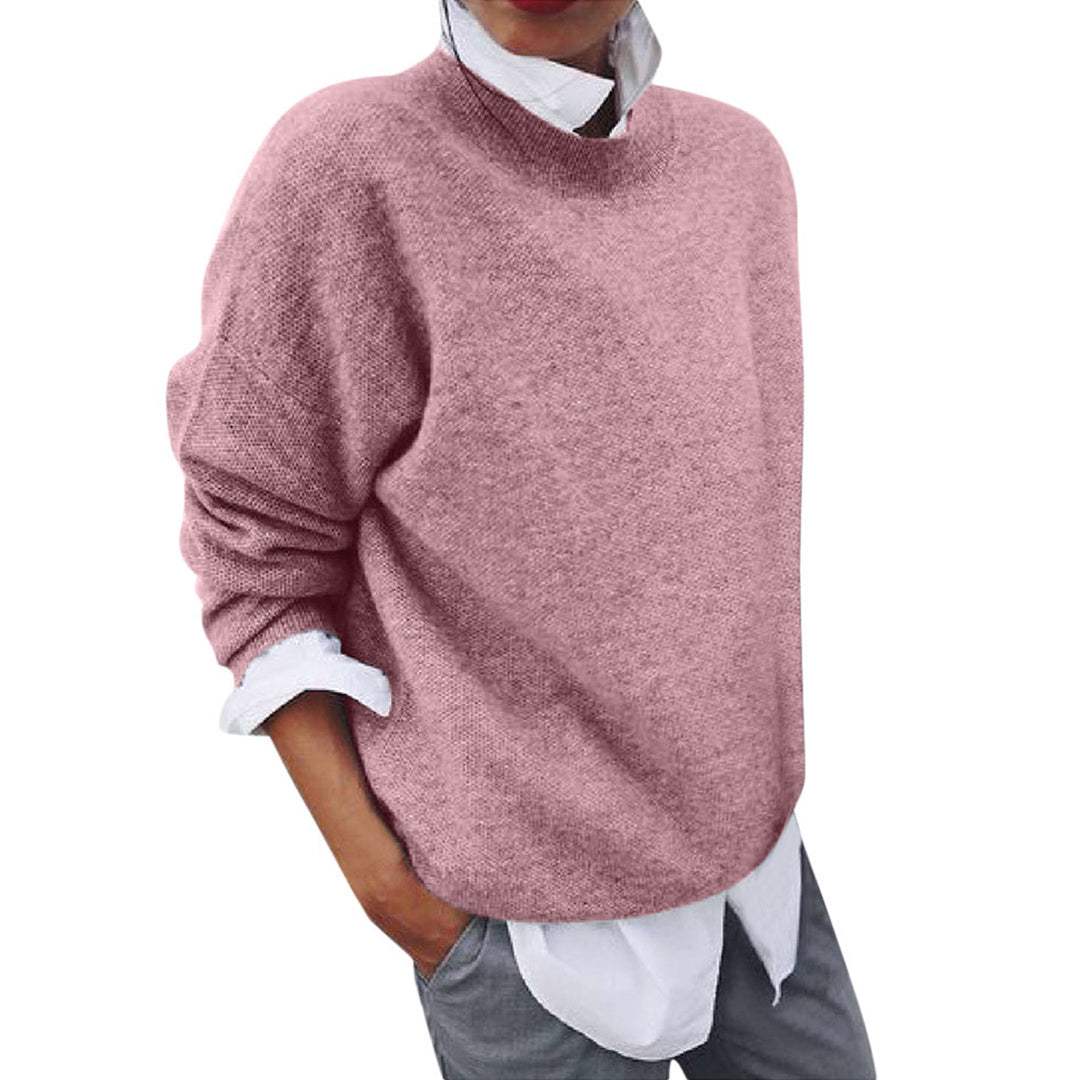 Voorkant roze wollen trui voor heren met daaronder een wit overhemd